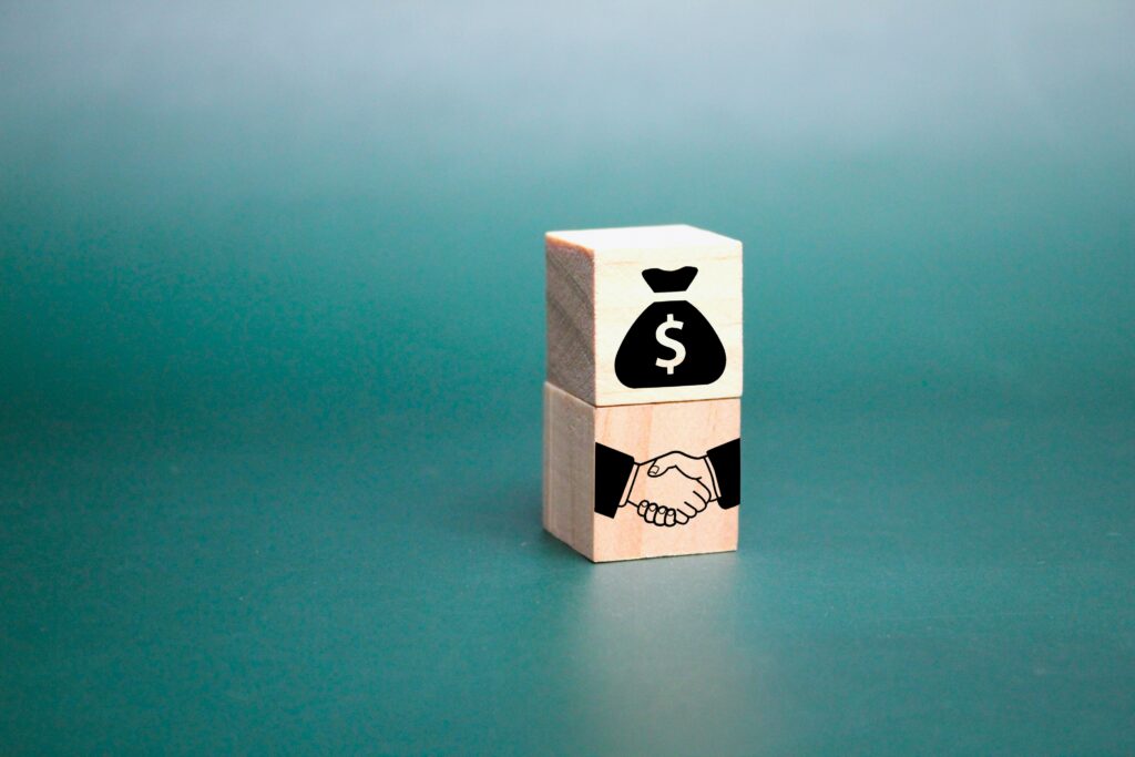wooden cube with money icon and two party agreemen 2023 01 06 22 26 55 utc scaled